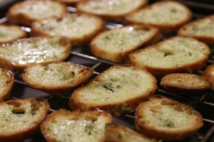 Arrange them on a baking rack rather than a flat baking sheet as the air can circulate and saves you having to turn them.